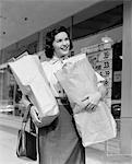 ANNÉES 1950 SOURIANT FEMME HORS ÉPICERIE TENIR LES SACS EN PAPIER BRUN AVEC POCHE SUSPENDUE SUR POIGNET