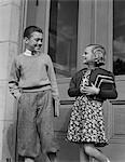 1940s SMILING BOY & GIRL HOLDING SCHOOL BOOKS BY DOORS