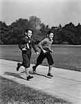 1930s - 1940s TWO SMILING BOYS RUNNING CARRYING SCHOOL BOOKS