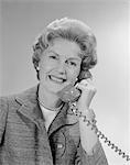 1960s PORTRAIT SMILING MATURE WOMAN TALKING ON TELEPHONE