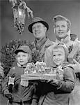 1950s - 1960s FAMILY BY LANTERN CARRYING WRAPPED CHRISTMAS PRESENTS