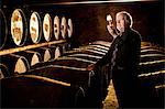 Worker testing whisky in distillery