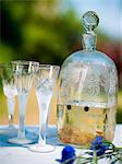 Drink bottle with glasses on table, close-up