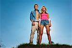 Couple standing on grassy hill