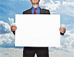 Businessman holding blank card