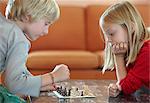 Children playing chess in living room