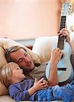 Father and son playing ukulele