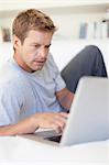 Man using laptop in bed