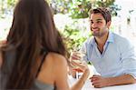 Couple having wine at table outdoors