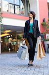 Businesswoman carrying shopping bags