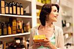 Woman examining box in store