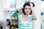 Frustrated woman pumping gas into hair