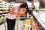 Woman smelling fruit at grocery store