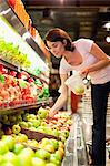 Woman selecting fruit at grocery store