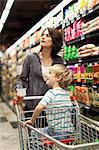 Woman grocery shopping with son