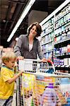 Woman grocery shopping with son