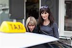 Women taking taxi cab in city