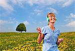 Woman listening to headphones outdoors
