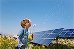 Boy in field with solar panels