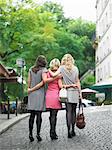 Women walking on cobbled street