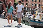 Couple walking by urban pier