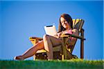 Woman Wearing Bathing Suit Listening to Music on iPad