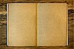 Blank brown notepad on the wood background