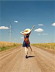 Rock girl with guitar at countryside.