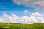 Electricity power wind generator pole against blue sky background