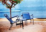 Detail of modern garden chairs with little tree