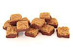 Chocolate and flapjack candy squares isolated over white background.