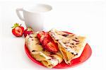 sweet pancakes with strawberries on red plate