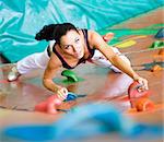 women climbing on a wall in an outdoor climbing center