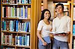 Students holding books in the library