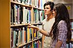 Students choosing a book in a library