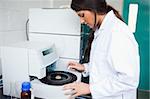 Scientist using a centrifuge in a laboratory