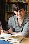 Portrait of a smiling student in a library