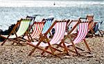 Deckchairs on Brighton beach in summer, Sussex, England, UK