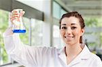 Cute science student holding an Erlemeyer flask in a laboratory