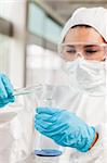 Portrait of a protected scientist pouring liquid in a laboratory