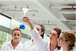 Science students looking at a flask in a laboratory