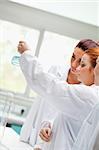 Cute chemistry students looking at a liquid in a laboratory