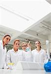 Portrait of chemistry students holding a flask while looking at the camera