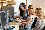 Smiling students working together in an IT room