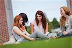 Friends having a good time while sitting on the lawn