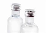Two bottles filled with liquor on white background