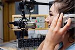 Smiling radio host speaking through a microphone