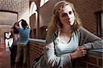 Lonely student standing up in a corridor