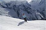 Snowboarder on ski slope. Ski resort. Caucasus Mountains, Dombay