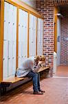 Portrait of a lonely student sitting in a corridor